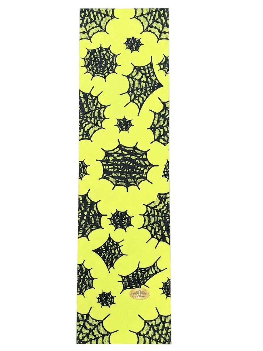 A long, narrow yellow item with an allover black spiderweb pattern, shown flat against a white background. A small oval brand patch is visible near the lower center.